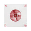 Red vinyl record on a white tile with decorative elements