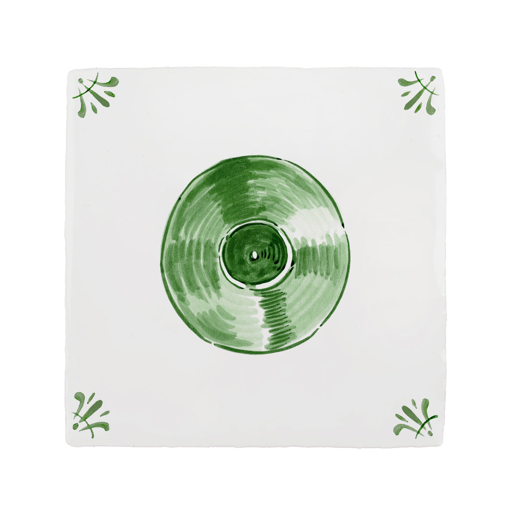 Green vinyl record on a white tile with decorative elements