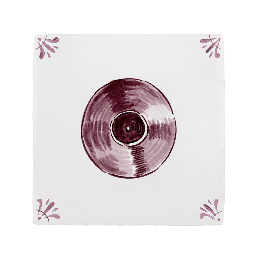 Vinyl record on a white tile with decorative elements