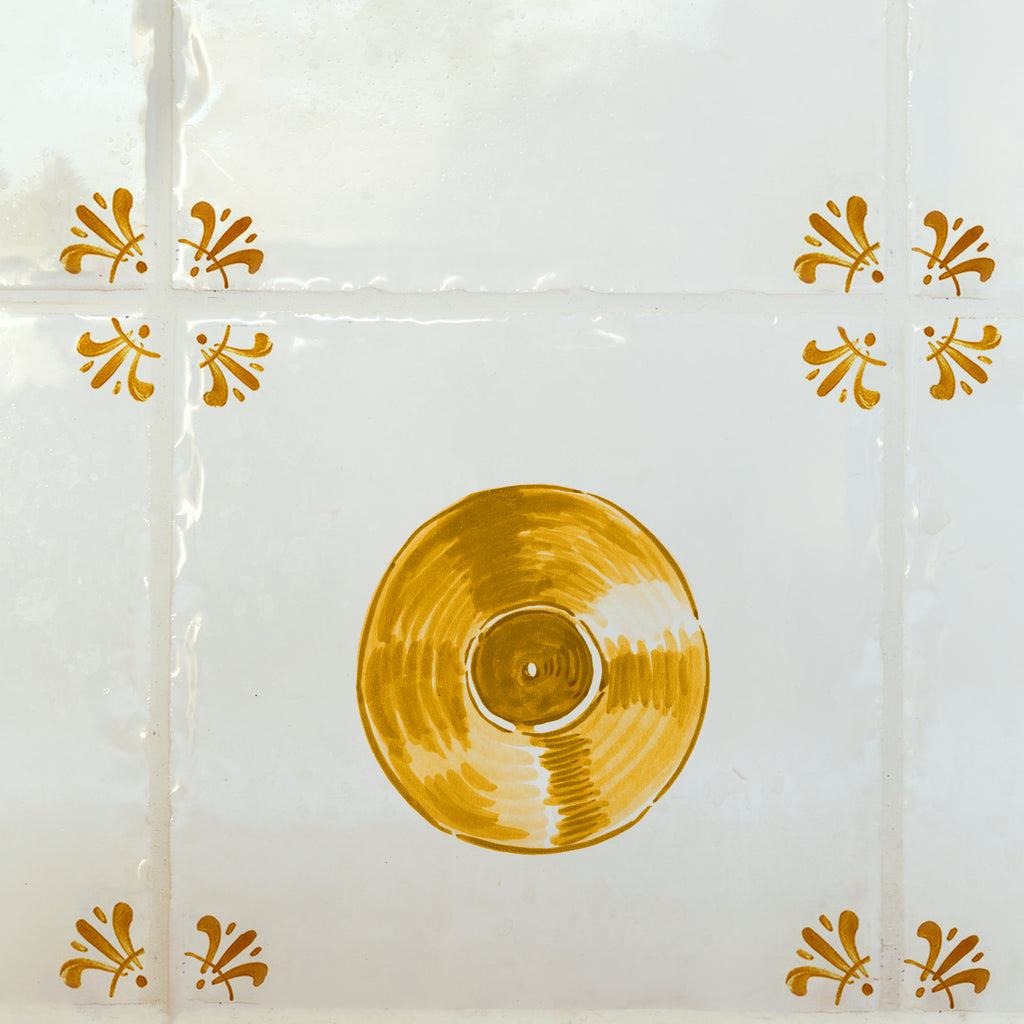 Mustard record on a white tiled background with decorative elements