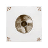 Vinyl record on a white tile with decorative elements