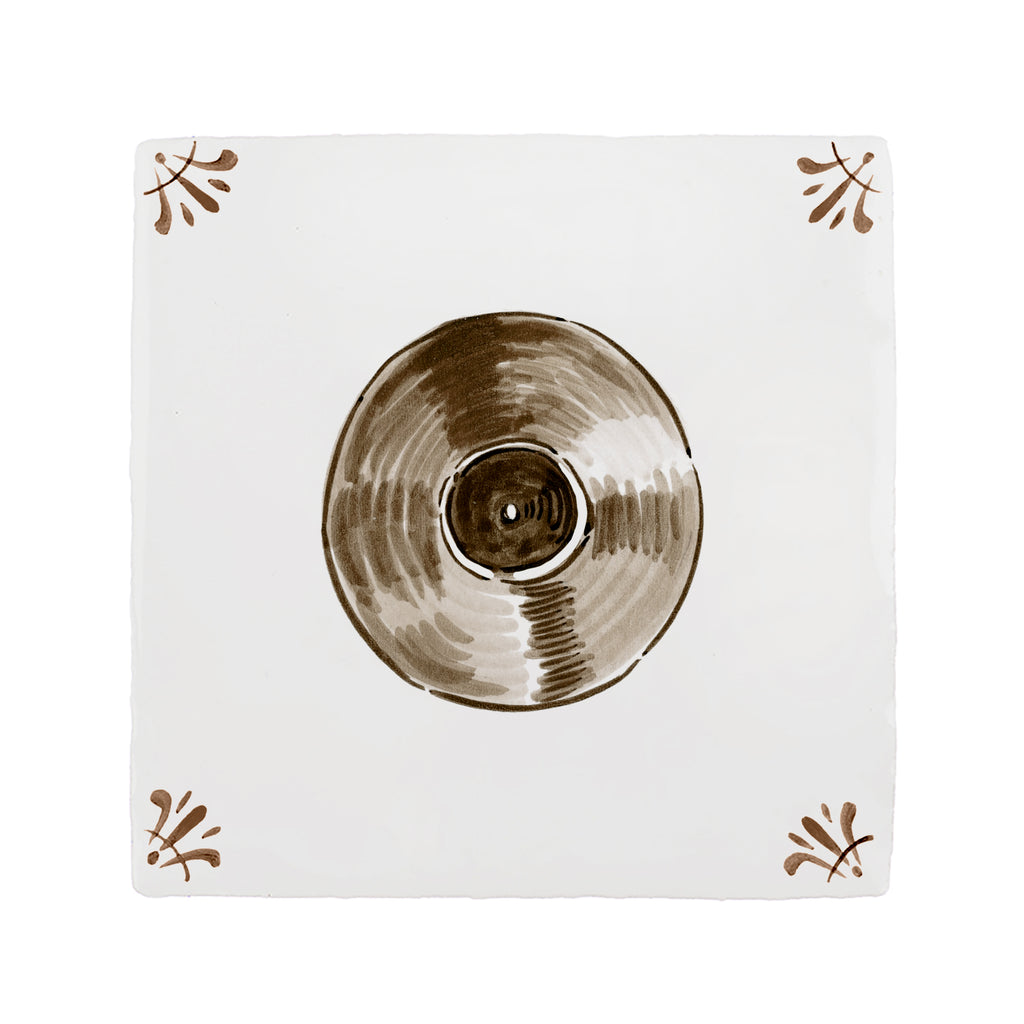 Vinyl record on a white tile with decorative elements