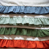 Stack of multicolored ruffled fabrics with a white background